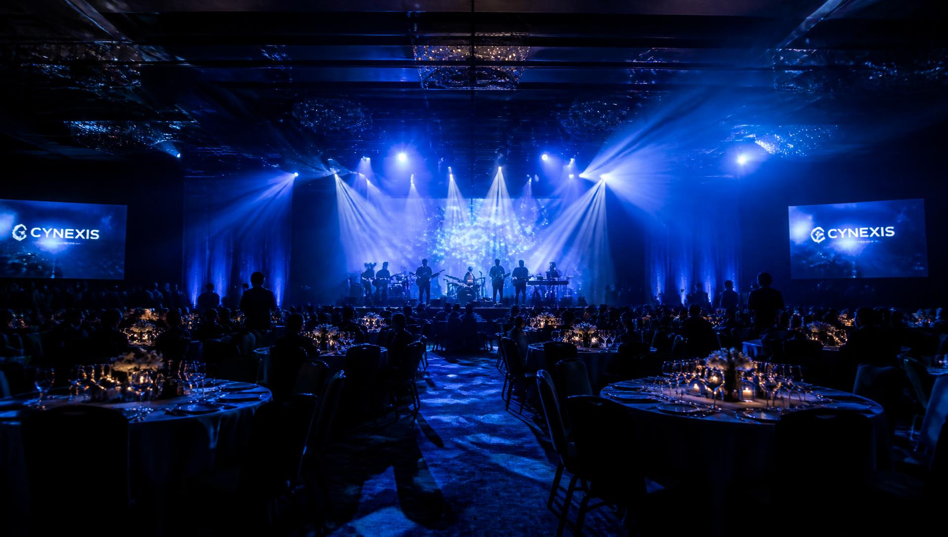 Live band performing at a corporate gala under blue stage lighting